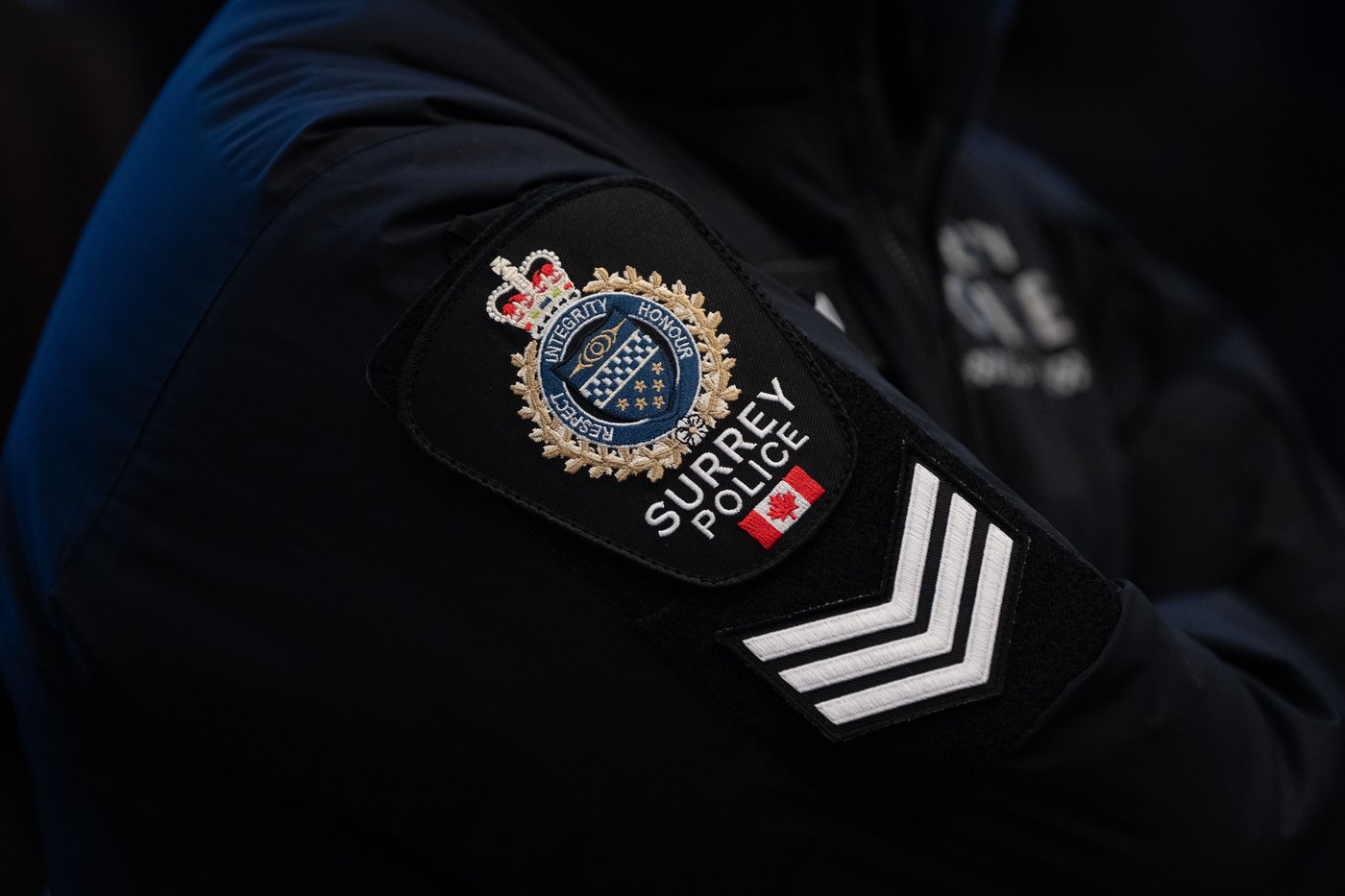 A Surrey Police patch is worn by an officer at RCMP "E" Division headquarters in Surrey, B.C., on Thursday, Feb. 19, 2026. THE CANADIAN PRESS/Ethan Cairns