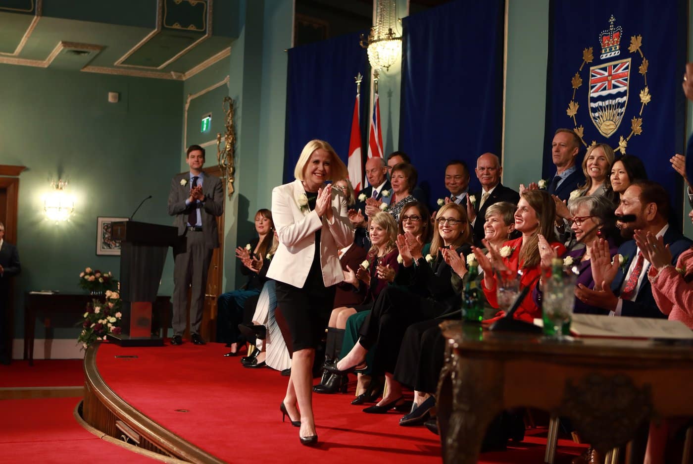 Premier David Eby looks on as Minister for Education and Child Care Lisa Beare walks on stage during the swearing-in ceremony at Government House in Victoria, Monday, Nov. 18, 2024. The nine Greater Victoria school trustees fired by the British Columbia government filed a court petition in an effort to get their jobs back, and the government's case fell apart due to document disclosure 'errors.' THE CANADIAN PRESS/Chad Hipolito