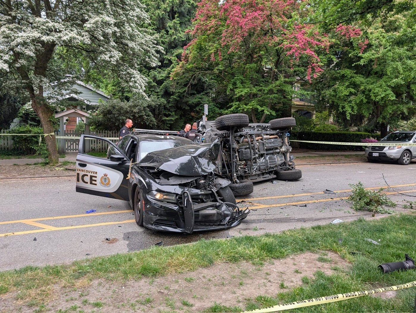 A man who drove along a sidewalk, knocking into trees, vehicles and a senior on a scooter is in custody after two Vancouver police officers used their vehicle to stop the driver. A damaged VPD squad car and overturned vehicle are seen in a handout image published by police to social media site X on Friday, May 15, 2026. THE CANADIAN PRESS/Handout — Vancouver Police Department (Mandatory Credit)