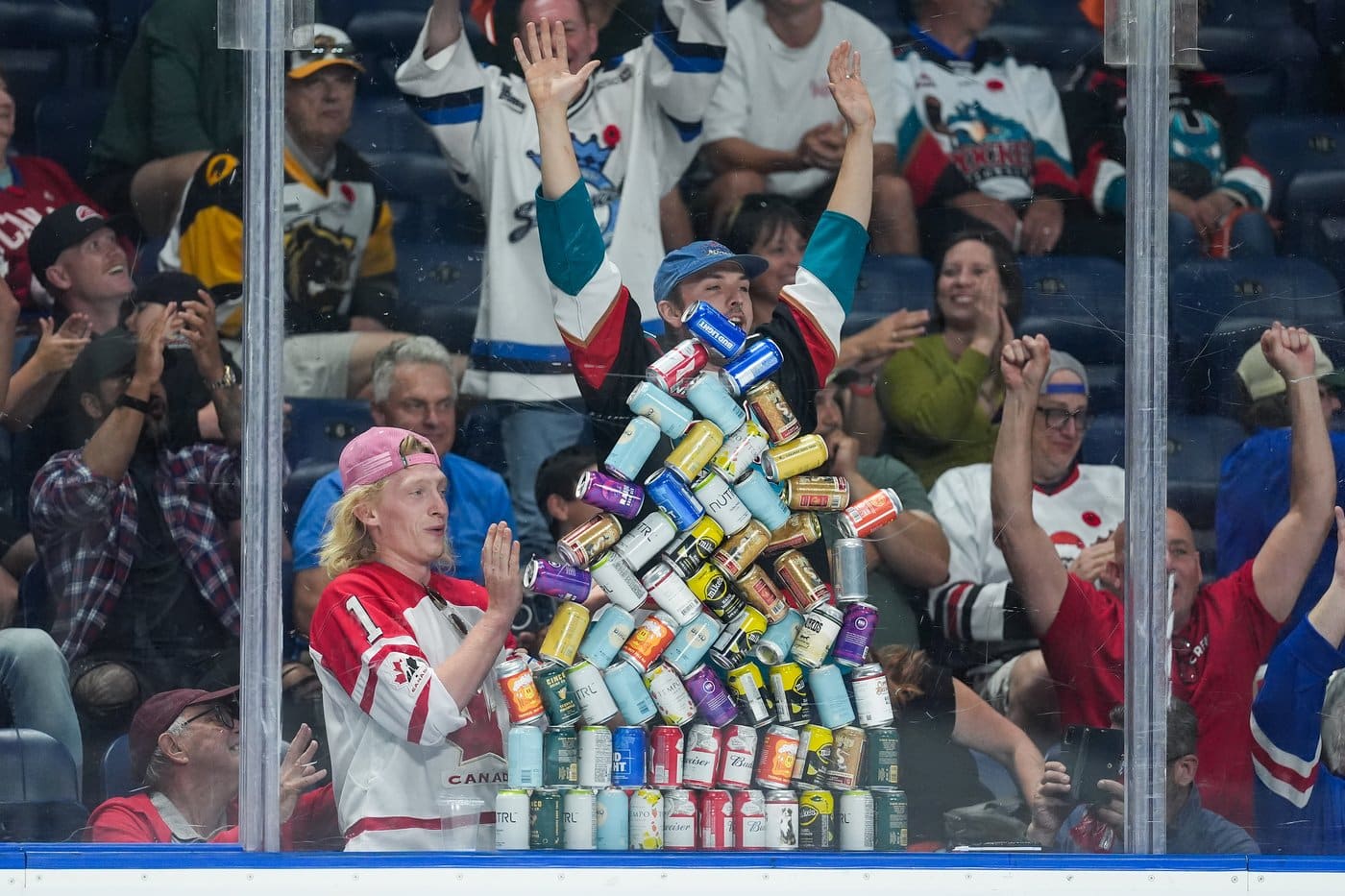 A report released by the B.C. provincial health officer says that while the alcohol use in the province has reached a 20-year low following a spike during the COVID-19 pandemic, it is still above the national and recommended levels. An alcohol can pyramid collapses after being built by spectators as the Kelowna Rockets and Kitchener Rangers play during the third period of a Memorial Cup hockey game, in Kelowna, B.C., on Friday, May 22, 2026. THE CANADIAN PRESS/Darryl Dyck