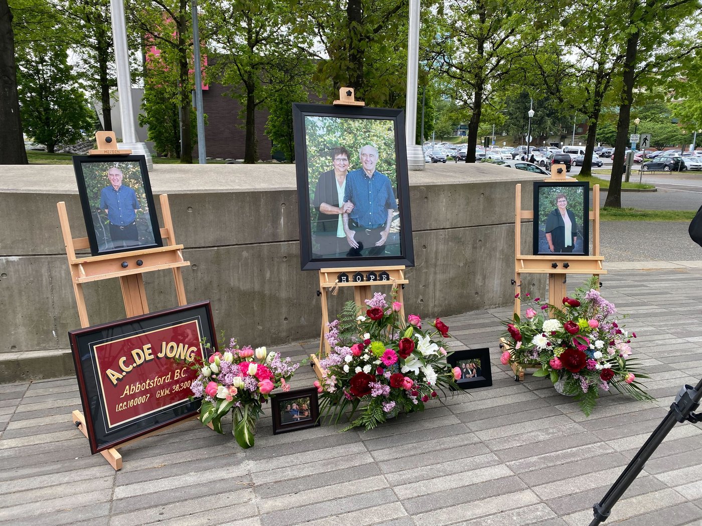 Photos of Arnold and Joanne De Jong are seen outside the Abbotsford, B.C., law courts on Friday, May 8, 2026, after a judge's guilty verdict against three men for their murder in May 2022. THE CANADIAN PRESS/Darryl Greer