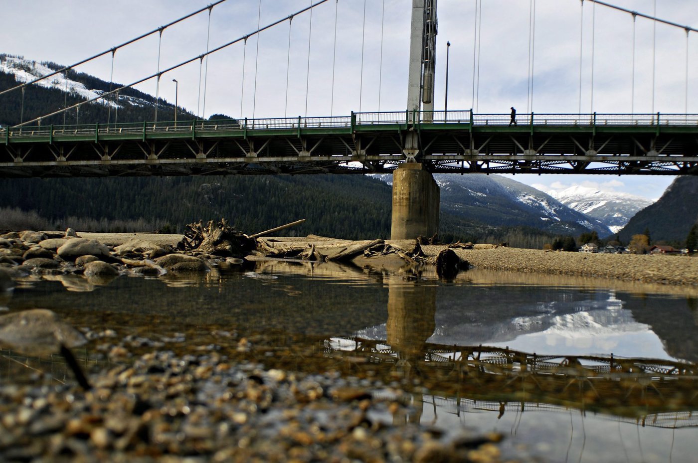 REVELSTOKE, BC — A man crosses a bridge over the Columbia River in Revelstoke on Sunday March 14, 2010. Photo by Daniel Hayduk
