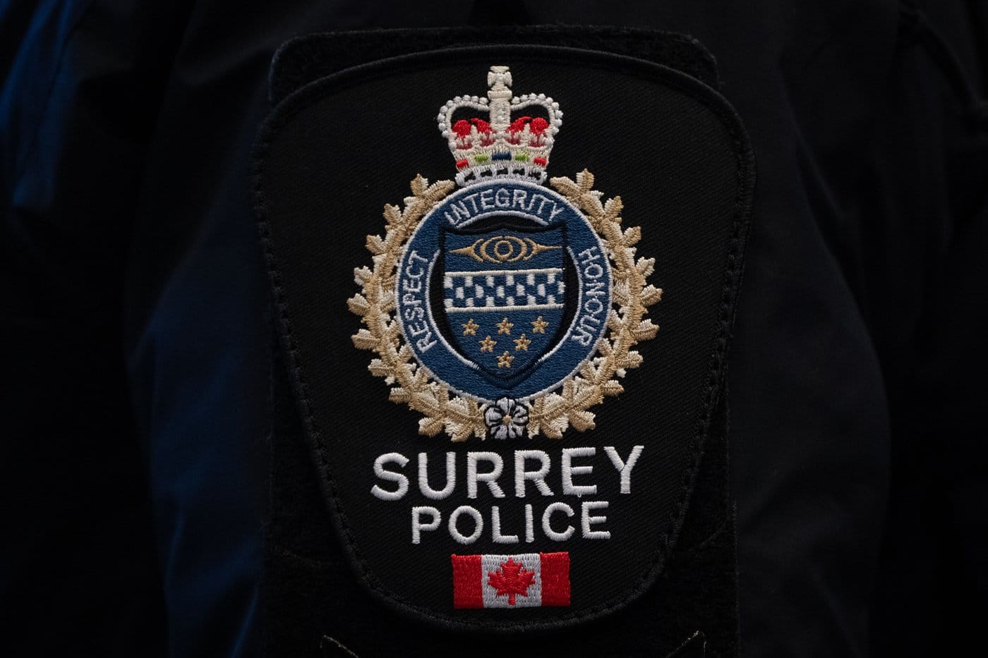 A Surrey Police patch is worn by an officer at RCMP "E" Division headquarters in Surrey, B.C., on Thursday, Feb. 19, 2026. THE CANADIAN PRESS/Ethan Cairns