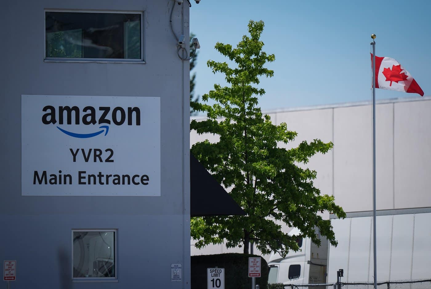 A Canadian flag flies outside Amazon's YVR2 fulfillment centre, in Delta, B.C., on Friday, July 11, 2025. THE CANADIAN PRESS/Darryl Dyck