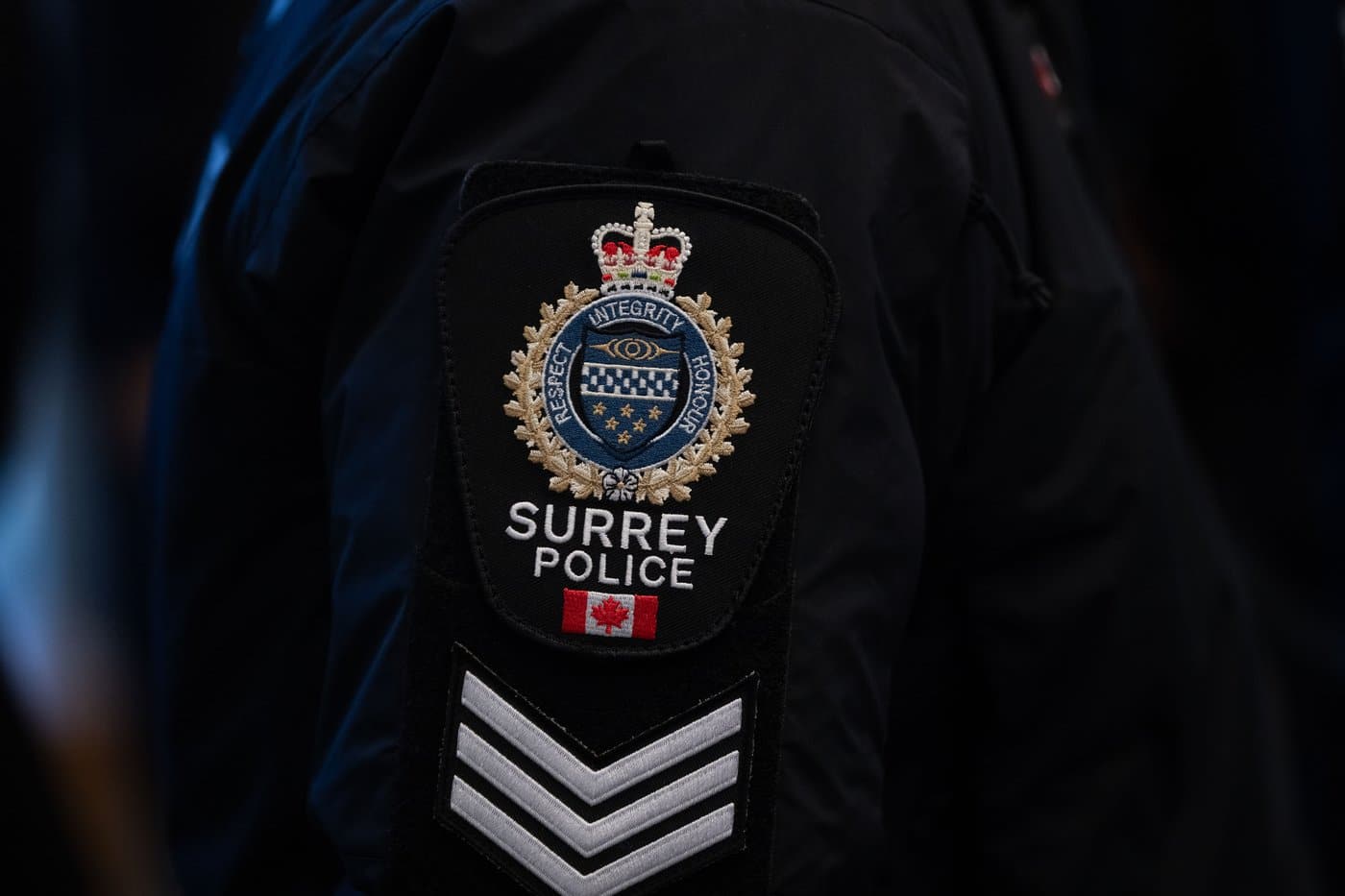 A Surrey Police patch is worn by an officer at RCMP "E" Division headquarters in Surrey, B.C., on Thursday, Feb. 19, 2026. THE CANADIAN PRESS/Ethan Cairns