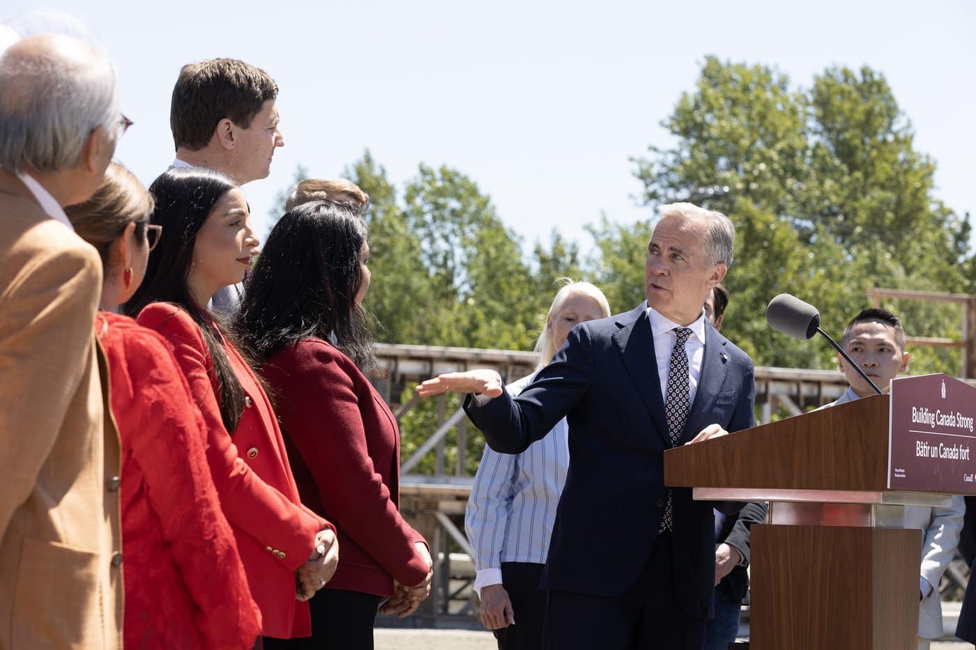 Prime Minister Mark Carney gestures toward B.C. Premier David Eby, while he speaks about housing during an announcement at a construction site in Vancouver, on Thursday, June 18, 2026. THE CANADIAN PRESS/Chad Hipolito