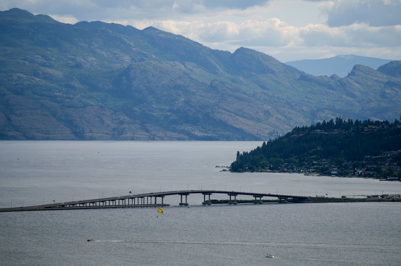 People parasail on Okanagan Lake as motorists travel over the William R. Bennett Bridge, in Kelowna, B.C., on Saturday, May 30, 2026. THE CANADIAN PRESS/Darryl Dyck