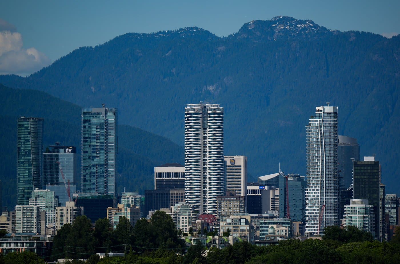 Condo and office towers line the downtown skyline with the north shore mountains in the distance, in Vancouver, on Friday, July 4, 2025. THE CANADIAN PRESS/Darryl Dyck