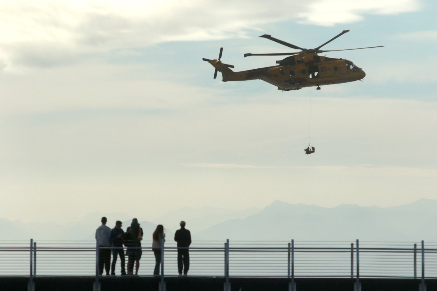 People look on as a military AgustaWestland CH-149 Cormorant helicopter demonstrates a search and rescue operation demonstration in this file photo taken in Victoria, on Sunday, Sept. 17, 2023. THE CANADIAN PRESS/Chad Hipolito