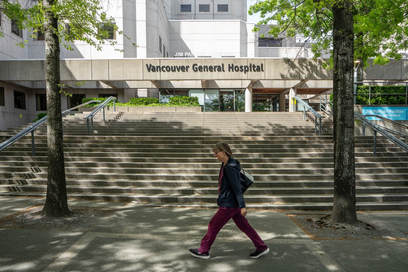 A hospital worker walks past the entrance to the Vancouver General Hospital in Vancouver, B.C., on Tuesday, May 12, 2026. THE CANADIAN PRESS/Ethan Cairns