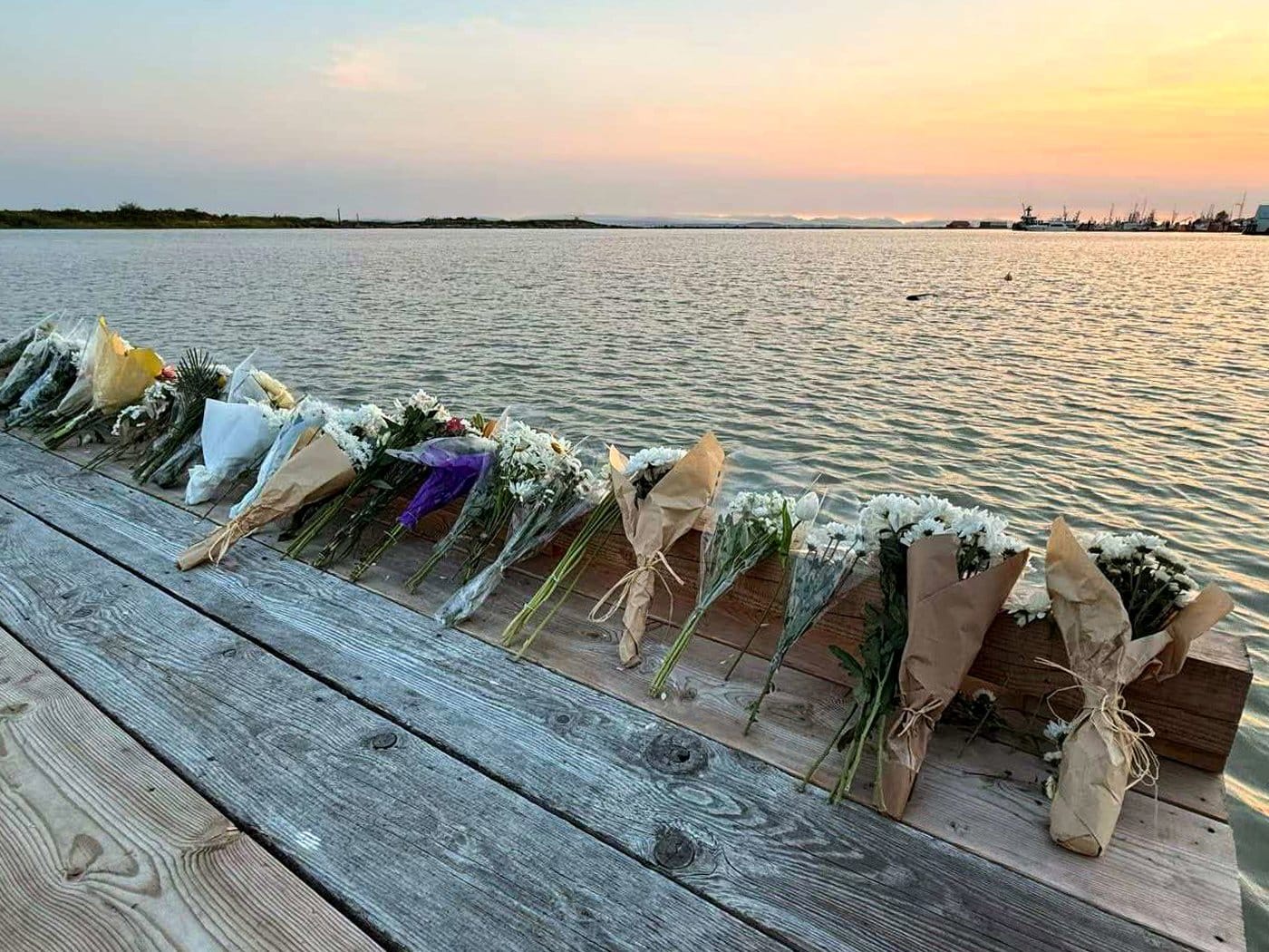 Flowers are seen placed alongside the Imperial Landing Dock in Richmond, B.C., in this handout photo, on Sunday, June 5, 2026, to pay tribute to six people who are presumed drowned following the tragic capsizing, on Sunday, June 28, 2026, of a commercial charter fishing boat in the Strait of Georgia. THE CANADIAN PRESS/Handout — Caryn Zhang (Mandatory Credit)