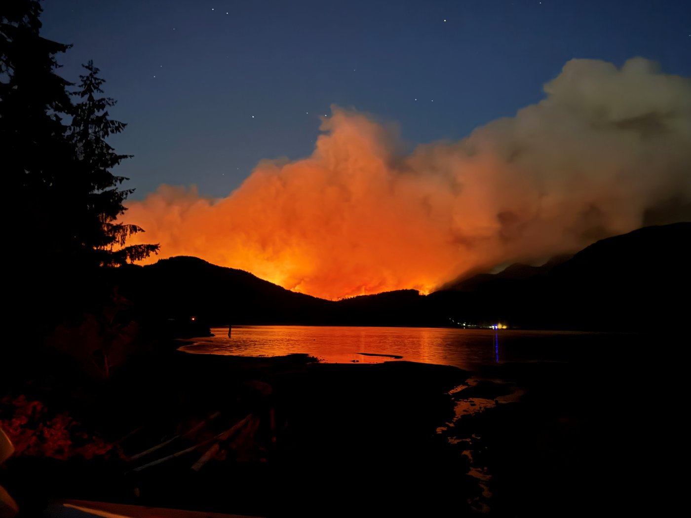 A wildfire is seen burning about 16 kilometres south of Port Alberni, B.C., on Monday, Aug. 11, 2025. THE CANADIAN PRESS/Evan Hammond