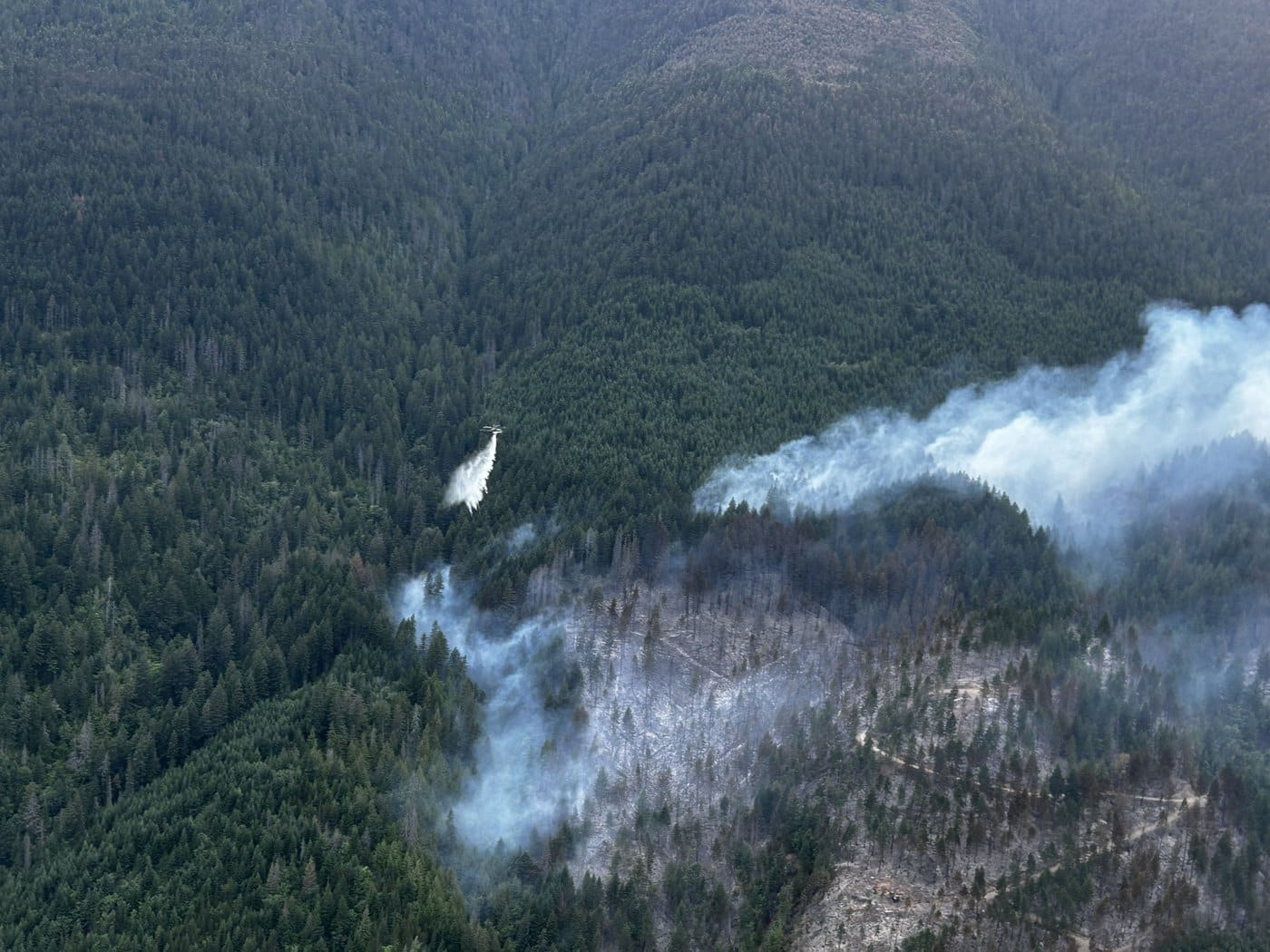 A helicopter buckets the Brunswick Creek wildfire north of Boston Bar, as shown in this handout photo provided by BC Wildfire Service, on Friday July 3, 2026. THE CANADIAN PRESS/Handout-BC Wildfire Service(Mandatory Credit)