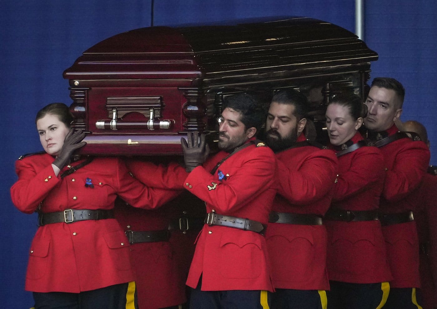 Pallbearers in red serge carry RCMP Const. Shaelyn Yang's casket to a hearse after her regimental funeral, in Richmond, B.C., on Wednesday, Nov. 2, 2022. THE CANADIAN PRESS/Darryl Dyck