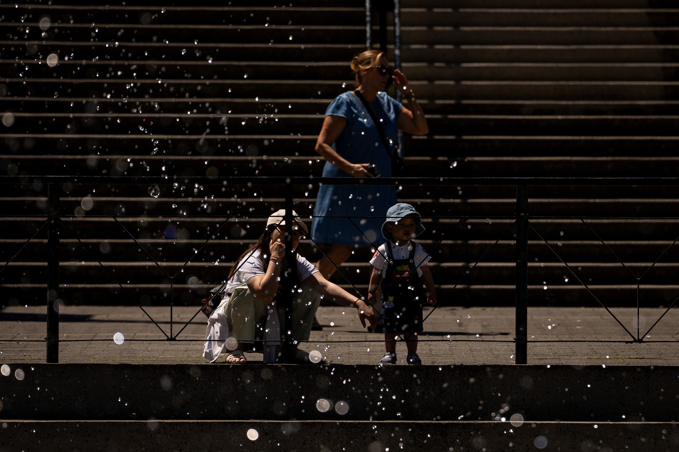 People watch a spray pad in Vancouver, B.C., Sunday, July 7, 2024. Heat warnings have been put in place for the Metro Vancouver area for elevated temperatures. THE CANADIAN PRESS/Ethan Cairns