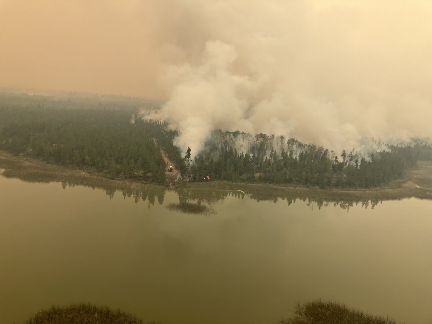 Firefighting crews conduct ignition operations in response to the Fiftynine Creek wildfire northwest of Clinton, B.C., in this handout photo, on Tuesday, July 21, 2026. THE CANADIAN PRESS/Handout, BC Wildfire Service (Mandatory Credit)