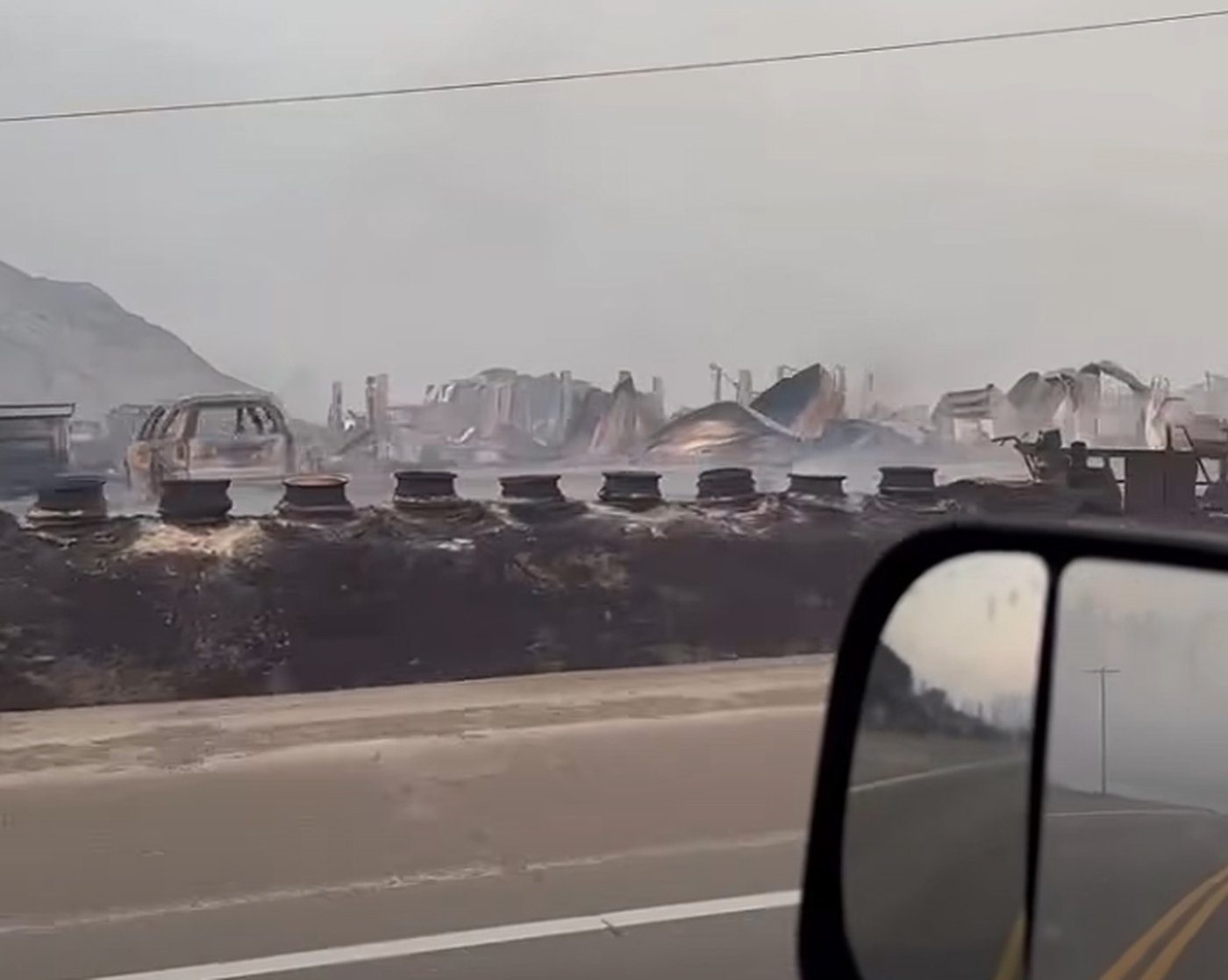 This handout still image from a video shot on Saturday, July 25, 2026, shows the smouldering aftermath of the Pear Lake wildfire that swept towards Clinton, B.C., a day earlier. THE CANADIAN PRESS/Handout — Facebook, Joey Johnson (Mandatory Credit)