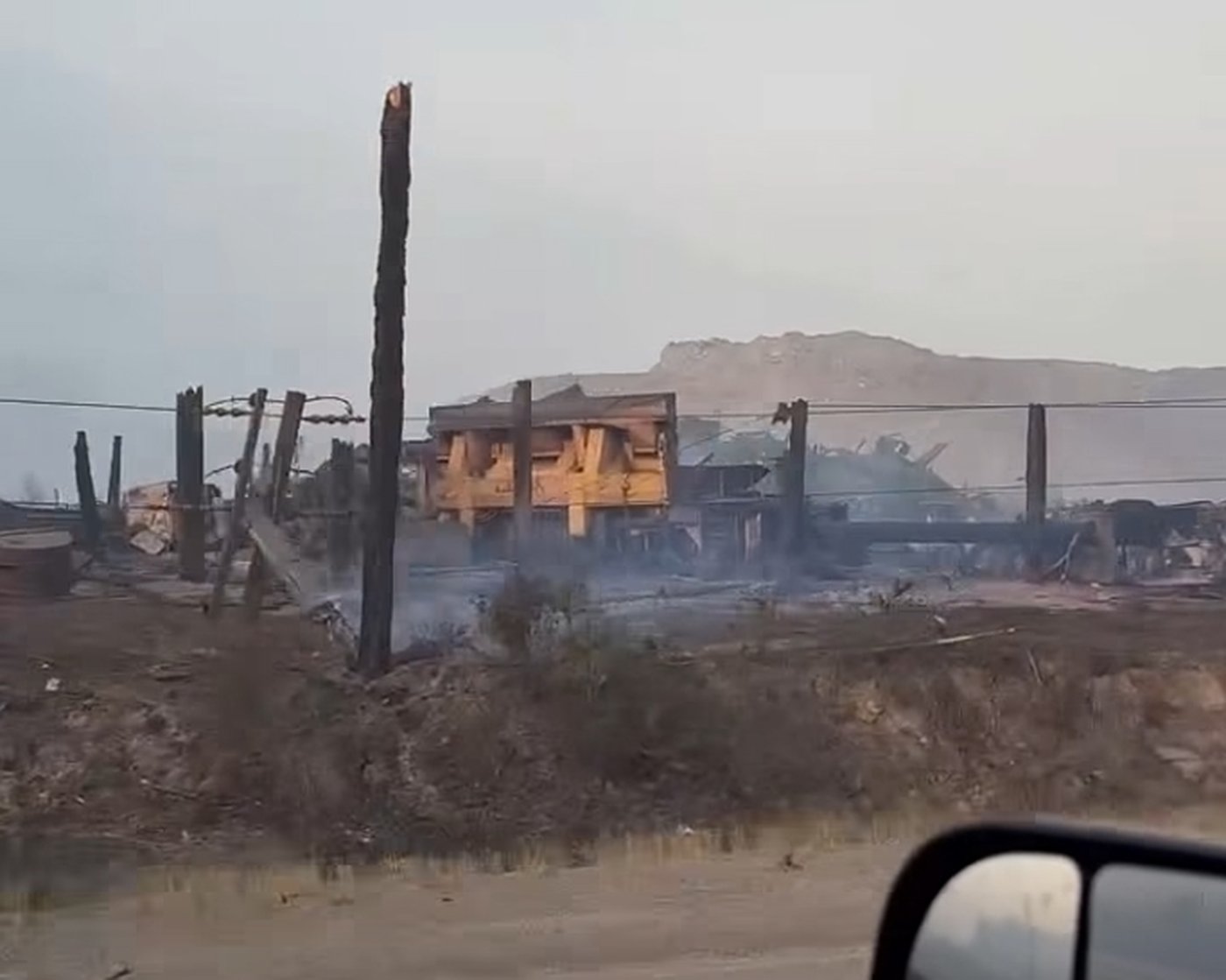 This handout still image from a video shot on Saturday, July 25, 2026, shows the smouldering aftermath of the Pear Lake wildfire that swept towards Clinton, B.C., a day earlier. THE CANADIAN PRESS/Handout — Facebook, Joey Johnson (Mandatory Credit)